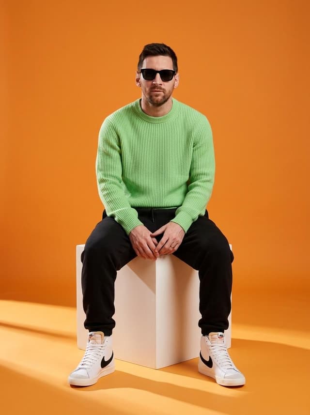 Nano Banana Prompt - A stylish male model sitting on a white cube in a minimalist
