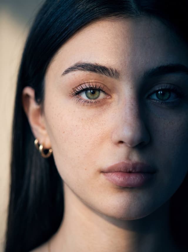 Nano Banana Prompt - Ultra-realistic close-up portrait of a young woman with fair