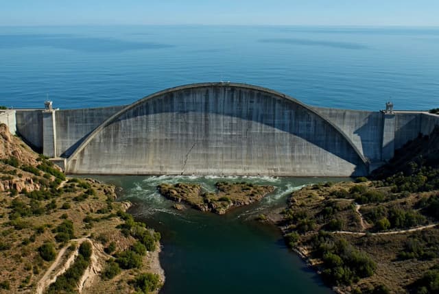 Grok Imagine Prompt - Start with an epic, ultra-wide aerial view of a massive conc