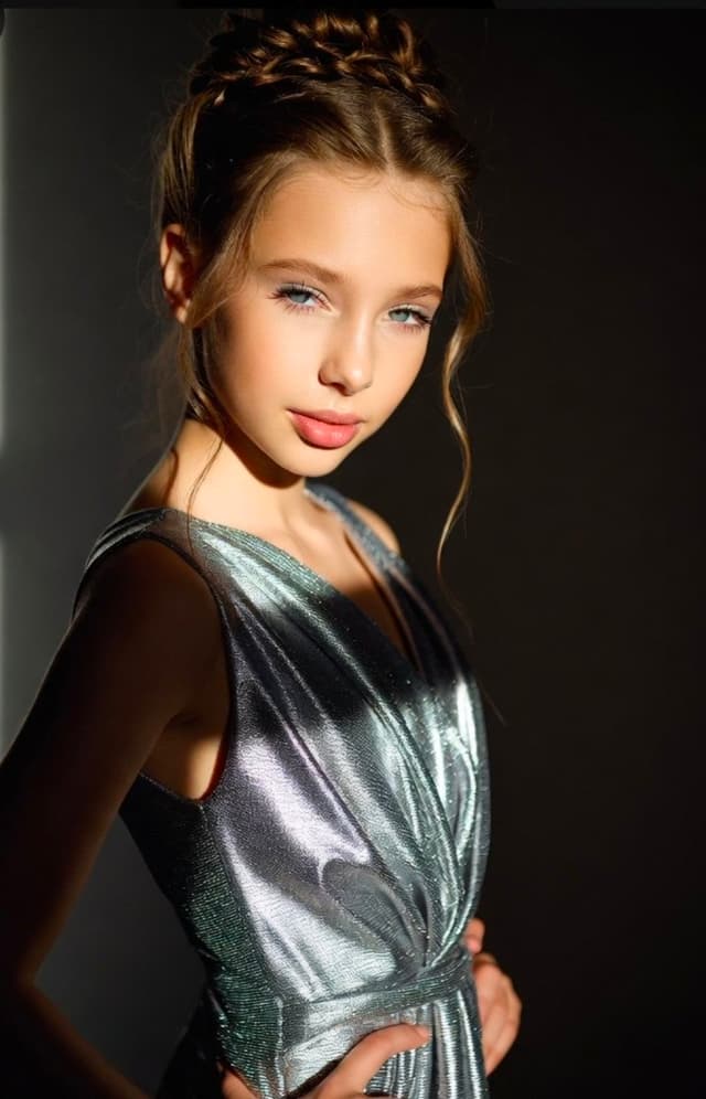 Grok Imagine Prompt - A high-fashion portrait of a graceful young girl with a clas