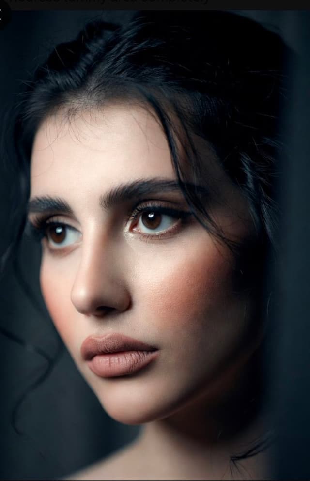 Grok Imagine Prompt - A striking, high-detail close-up portrait of a woman with in