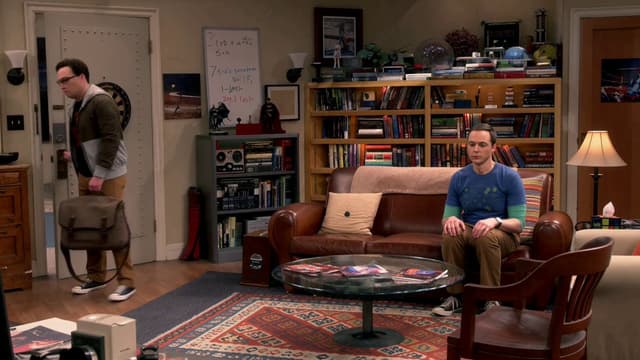 MiniMax Prompt - Sheldon Cooper sits in his spot on the couch, rigid and upri